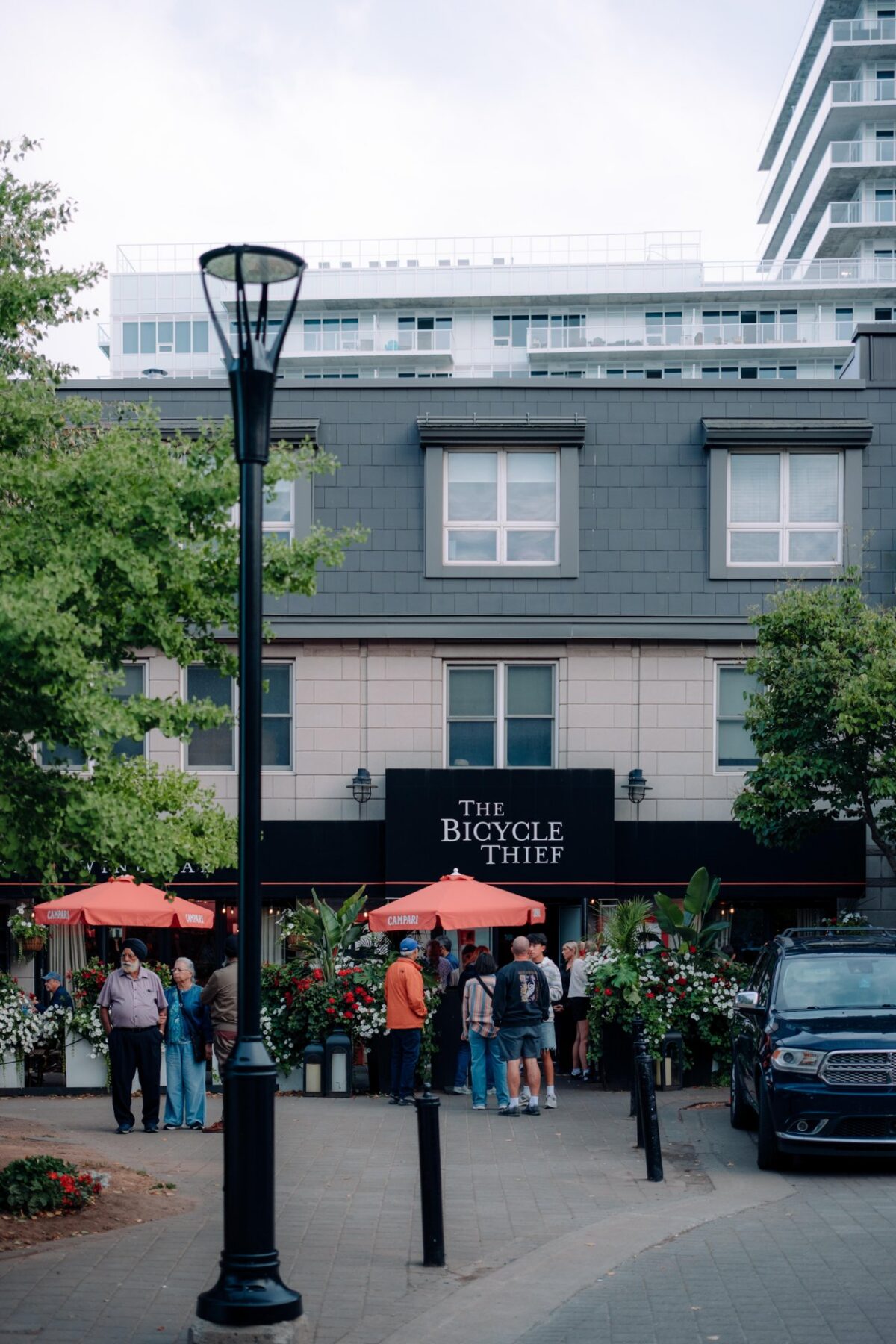 Exterior of The Bicycle Thief restaurant on the Halifax Waterfront with people gathered outside.