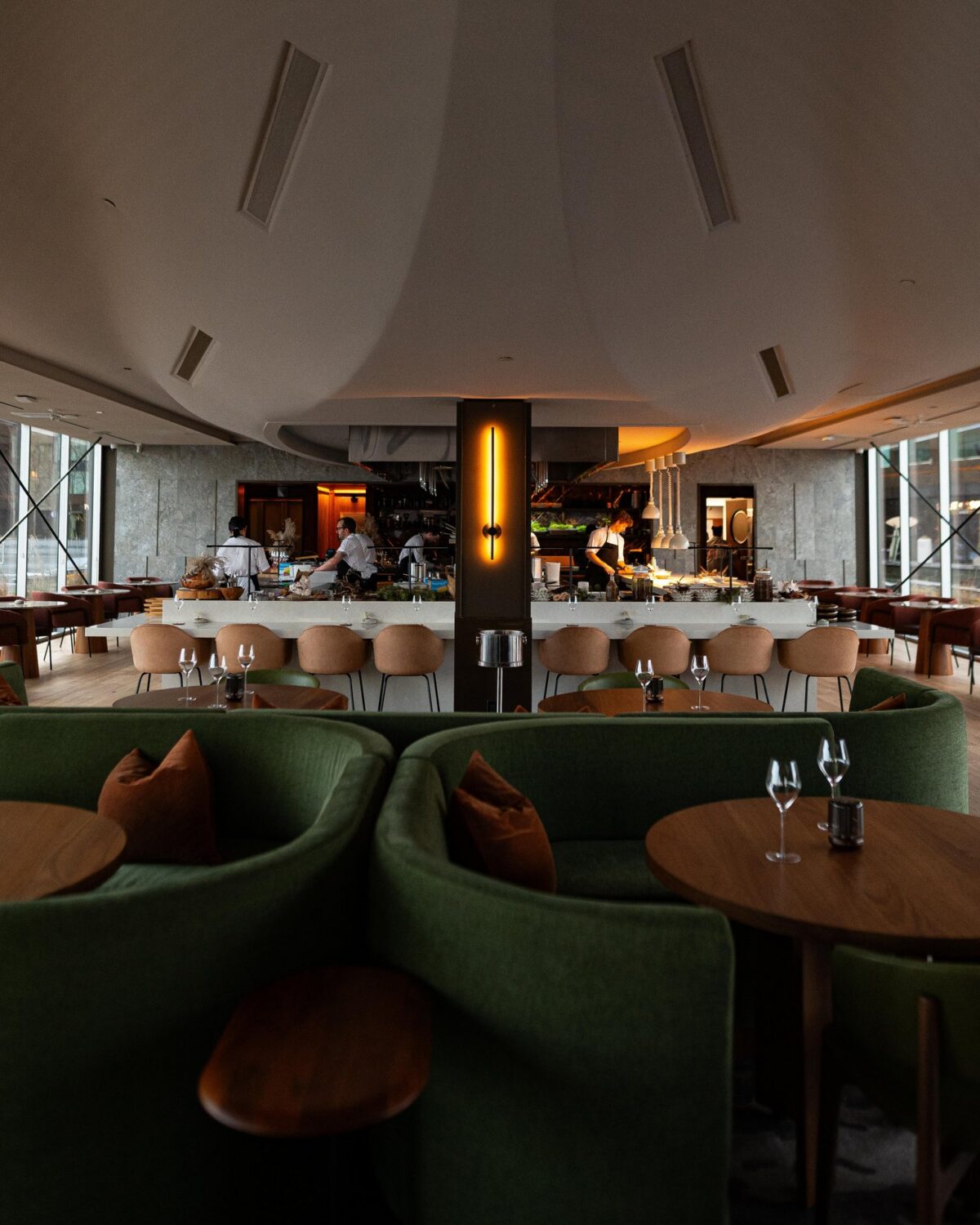 Interior of Mystic restaurant at Queen’s Marque on the Halifax Waterfront with open kitchen and dining space.