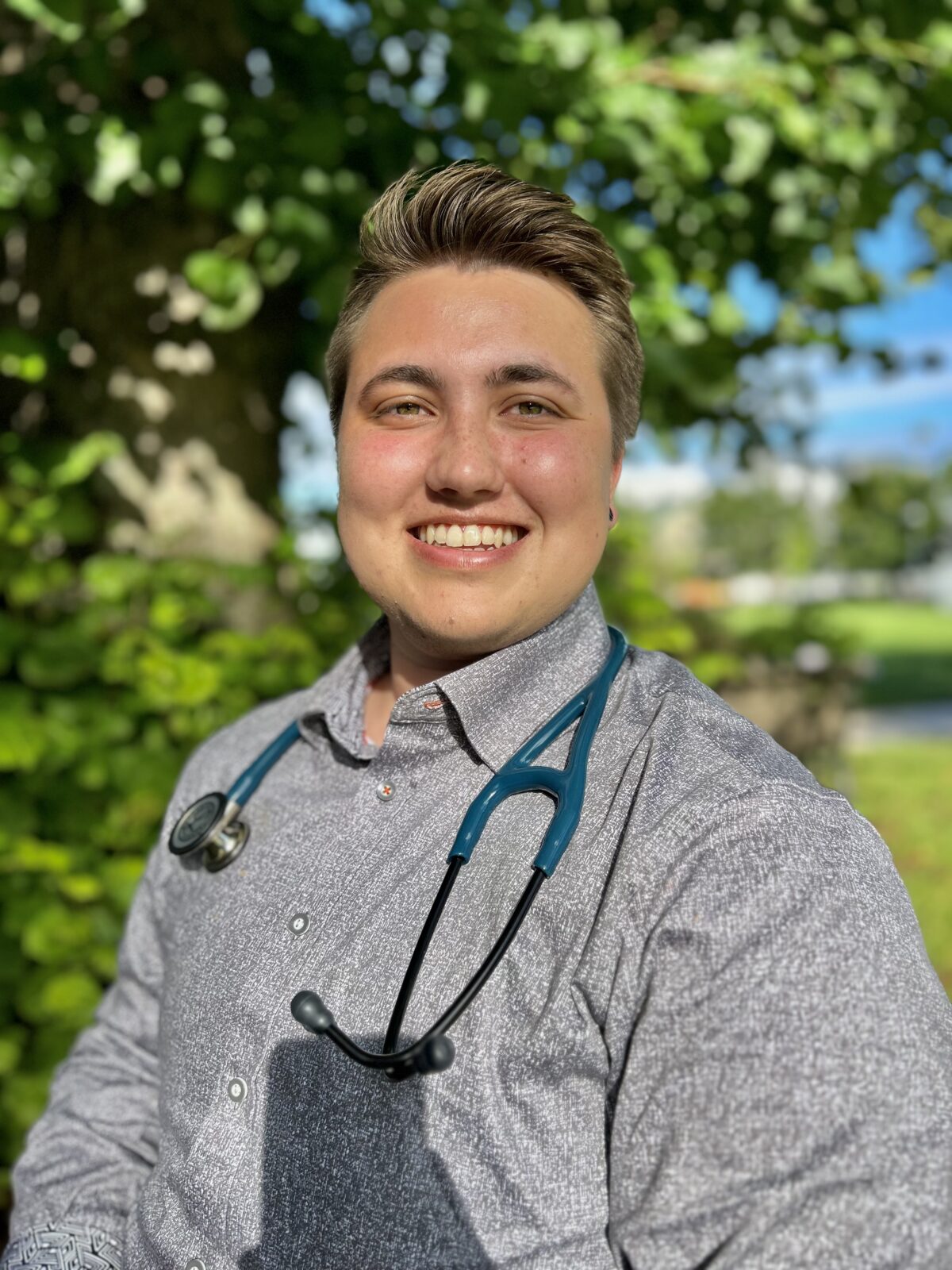 Portrait of Halifax local RJ Roggeveen outdoors wearing a stethoscope.