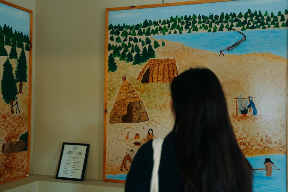 Visitor viewing art at L’Acadie de Chezzetcook.