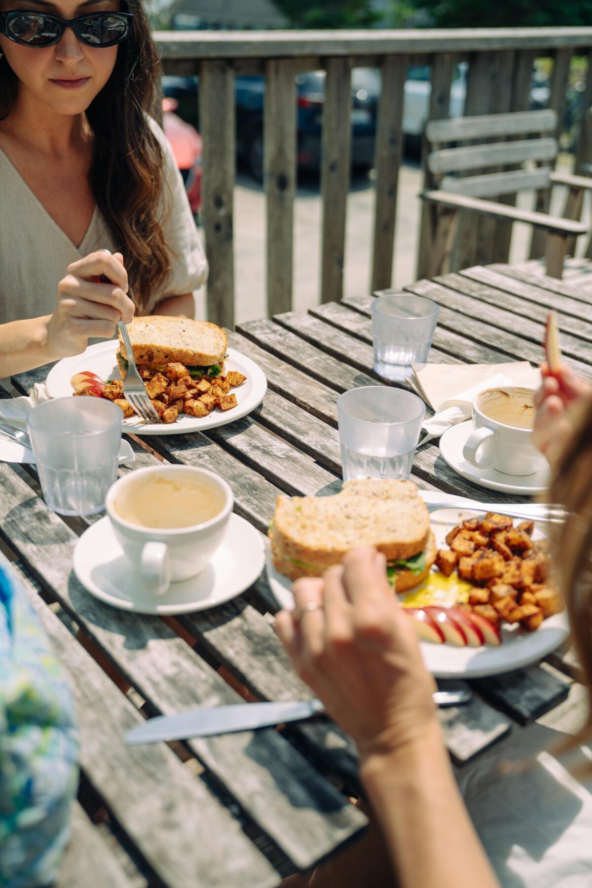 Guests enjoy breakfast and coffee on the patio at Rose & Rooster Cafe.