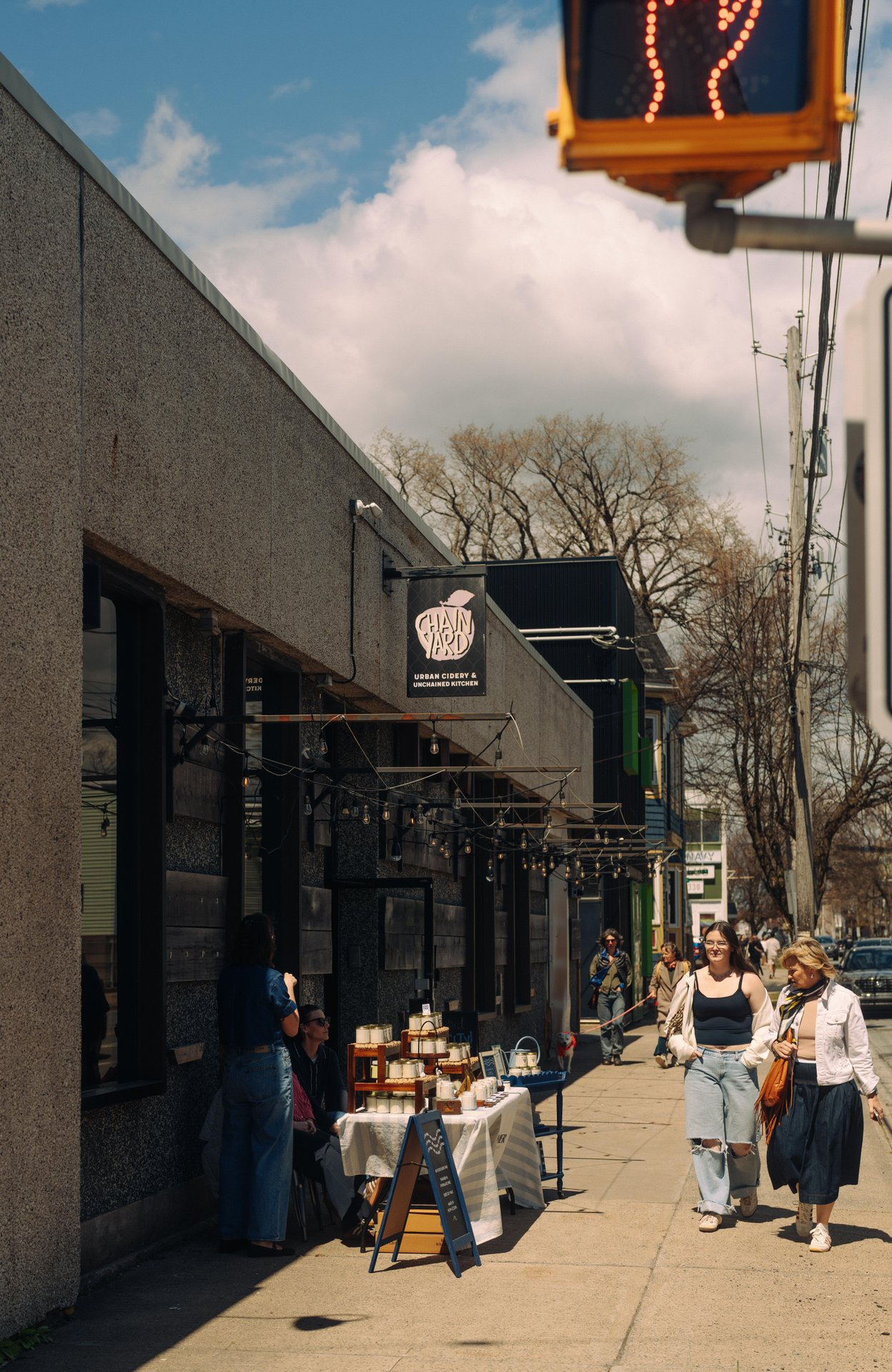 People outside Chain Yard Urban Cidery in North End Halifax on a sunny day.