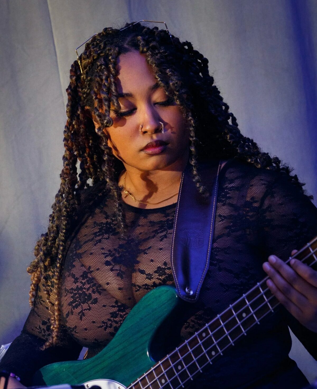 Halifax R&B artist Adina performing live on stage with a microphone.