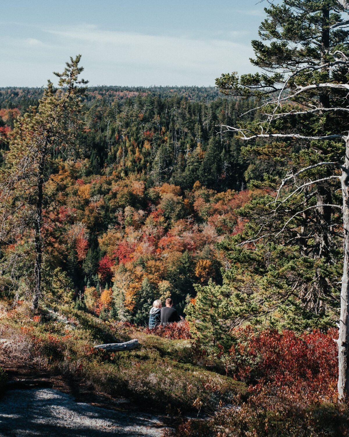 Hikers overlook colourful fall foliage along the Gibraltar Rock Loop in the Musquodoboit Valley.
