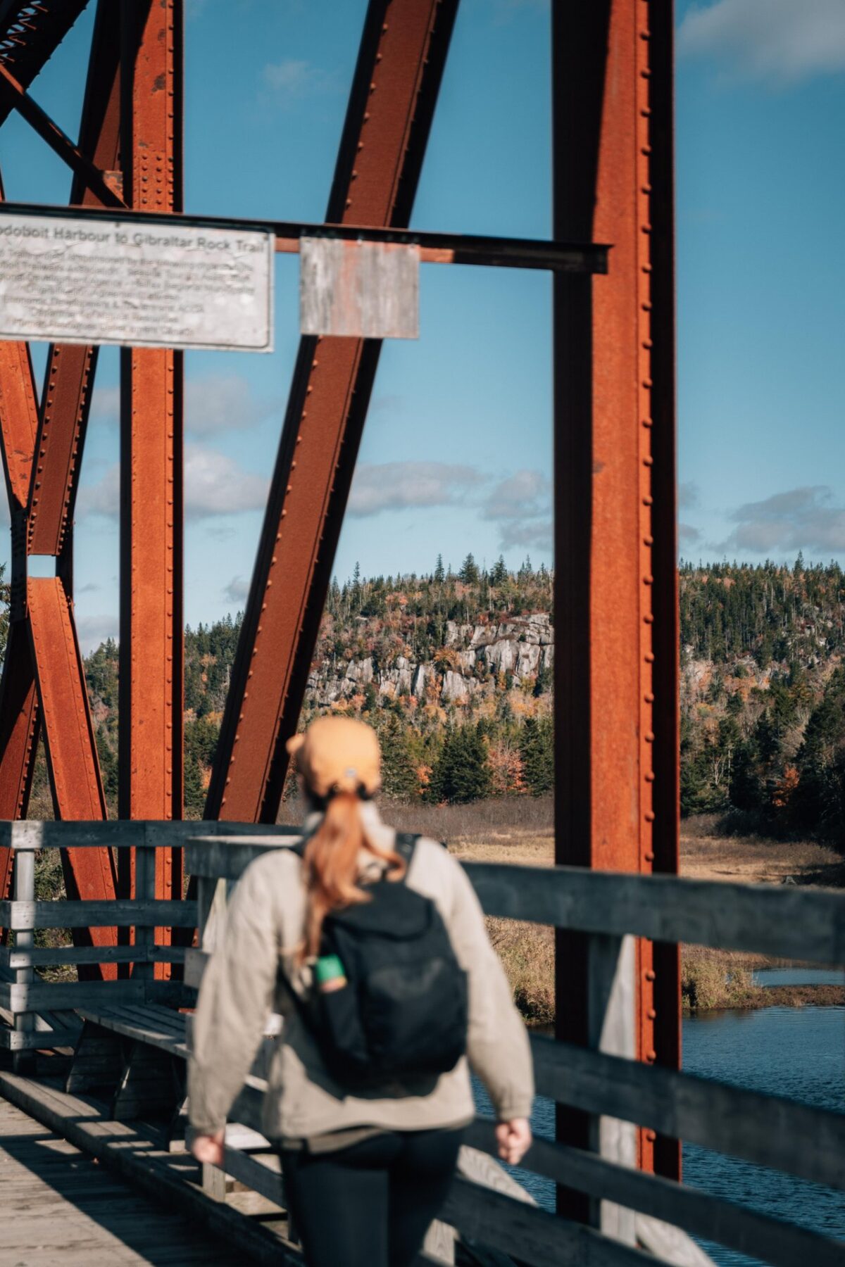 Hiker crosses a railway bridge on the Musquodoboit Trailway of the Eastern Shore.